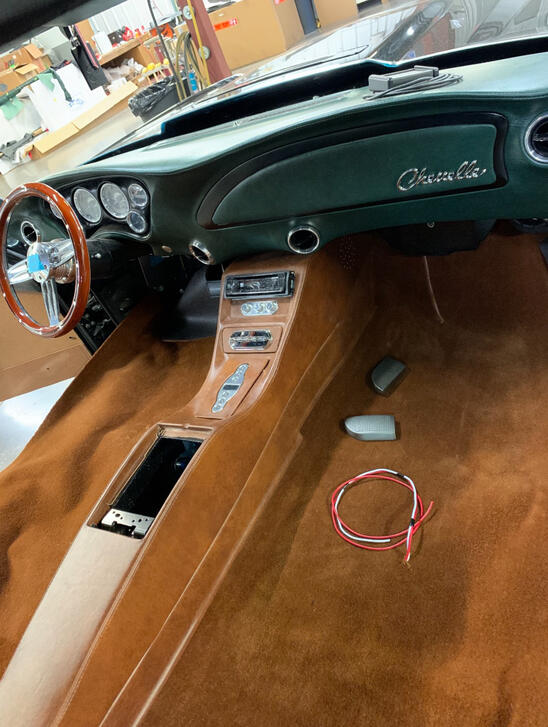 Chevelle interior upgrade: tan custom console and carpet with dark green dash and billet controls.