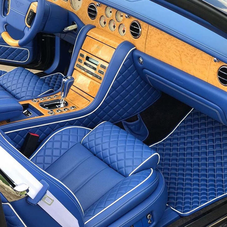 Custom Bentley interior: blue diamond-quilted leather with white piping and burled wood trim.
