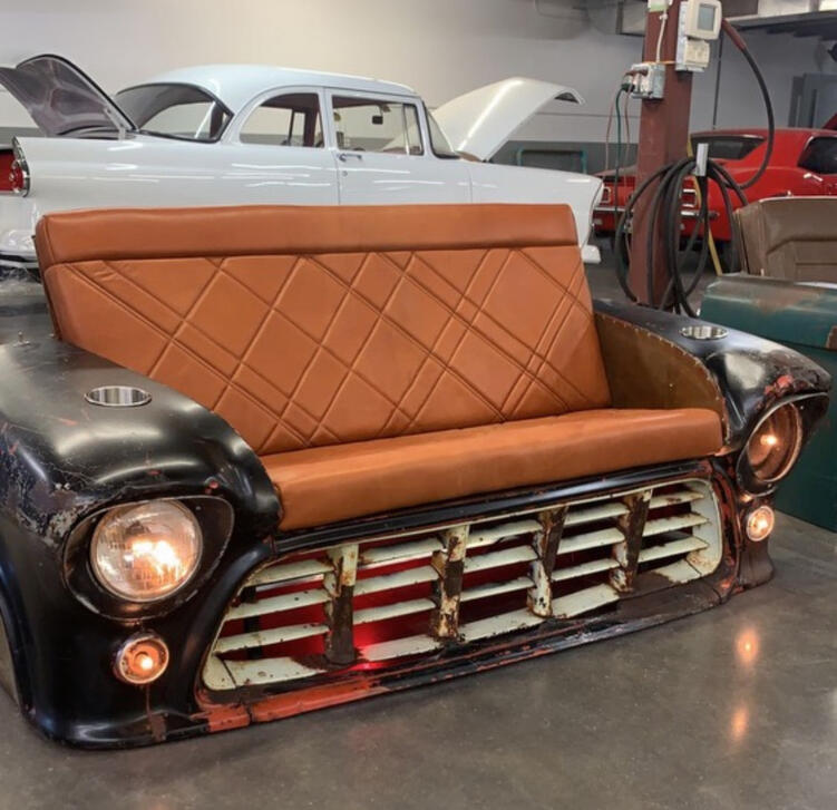 Automotive bench built from a classic front clip with diamond-stitched tan seat—functional art piece.